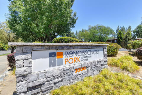 Rensissance Parks Apartments Community Monument Sign with surrounding trees and shrubs